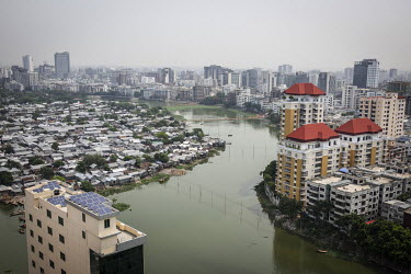 An aerial view of a slum and an area of high rise housing divided by a waterway in the Gulsan district.