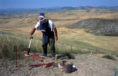 A deminer from the Halo Trust clearing anti-personnel mines with a detector in the Martuni 9 minefield near the city.