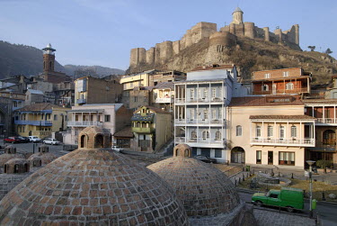 Old Tbilisi and the Narikala fortress viewed from the roof of a bath house. These famous sulphur baths or Abanotubani are situated underground and covered with beehive brick domes, through which the h...