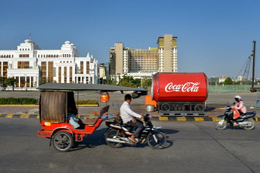 A 'tuktuk' transport passes a Coca-Cola stall on Diamond Island (Koh Pich).