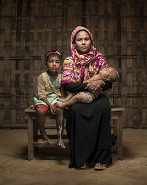 Rohingya refugees Fatima Khatun (25) with her five year old daughter Yeasamin Akter, and four month old Tawhid Uddin. They fled their village of Chorpara Rasidong because, as Fatima says, ''The milita...