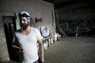 Jarvis (42), a Sikh migrant worker, at the dairy farm where he has now worked for more than nine years. He has a Kirpan (knife) tucked into his turban.