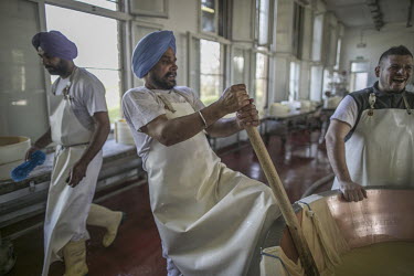 Sikh migrant worker (who became an Italian citizen in 2013) Singh Mahan (58) making Parmesan Reggiano cheese at the Roncocesi dairy factory.
