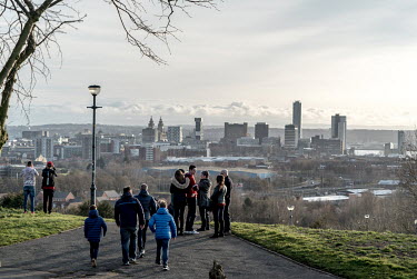 Liverpool FC fans stop to admire the view as they make their way back into the city from the Anfield stadium.