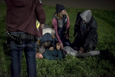 Members of a police Violent Crime Task Force detain a man during an operation against a gang operating in a park in north London.