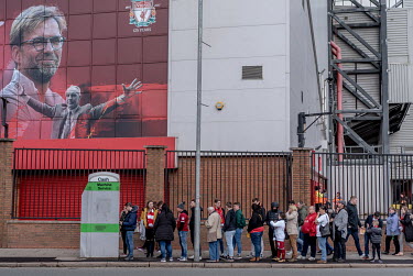 Fans of Liverpool FC queue for cash outside Anfield, the team's stadium, on a match day.