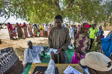 Habu Adamu (37), an IDP from Bosso in southeastern Niger, collecting the 30, 000 CFA monthly stipend from an NGO at the informal IDP camp in Diffa. This amount is far cry from the monthly need of him,...