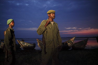 Two armed men from a mixed force of army and rangers who have been brought in to establish security and stop illegal fishing and poaching in and around Lake Edward and Rwindi National Park. From 1997...