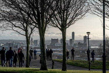 Liverpool FC fans stop to admire the view as they make their way back into the city from the Anfield stadium.