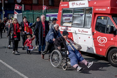Fans of Liverpool FC arrive for a match at the team's Anfield stadium.