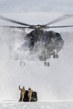 A British Merlin helicopter comes in to land to pick up a load during exercise Clockwork in the Arctic.  845 Naval Air Squadron is a squadron of the Royal Navy's Fleet Air Arm. Part of the Commando...