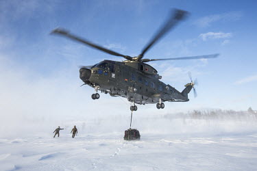 A British Merlin helicopter picks up a load during exercise Clockwork in the Arctic.  845 Naval Air Squadron is a squadron of the Royal Navy's Fleet Air Arm. Part of the Commando Helicopter Force, i...