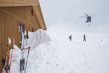 Soldiers collect firewood dropped off by helicopter at the newly built Vouma cabin in the Dividalen National Park, a part of the Norwegian Trekking Association network. As a goodwill gesture, and part...