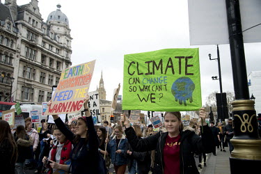 Pupils hold up placards during a school student's 'climate strike' demonstration in central London.