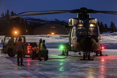 A British Merlin helicopter about to go on a night time sortie during exercise Clockwork in the Arctic.  845 Naval Air Squadron is a squadron of the Royal Navy's Fleet Air Arm. Part of the Commando...