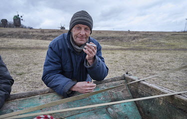 A man smokes a cigarette during a celebration for Maslenitsa (Maslyana) a Slavic pagan holiday when people bid farewell to winter and welcome the spring.