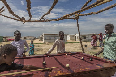 A group of boys playing pool at the Bakassi camp for internally displaced camps.