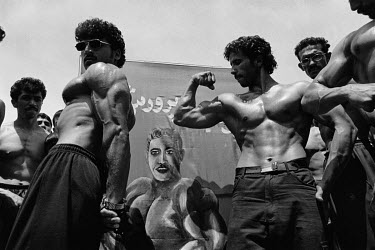 Bodybuilders showing their muscles during the celebrations to mark the tenth anniversary of the Soviet withdrawal.