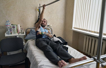 Aleh, exercising his right hand, from an Ukrainian army infantry regiment, was injured by a sniper near Horlivka. As soon as his arm heals, he says, he will return to the front to defend his homeland.