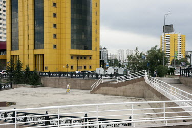 A modernist highrise building with a yellow facade.