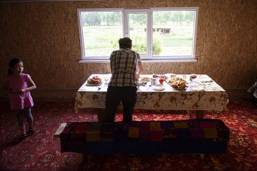 Kamaia sets a table for guests. Kamaia comes from a nomadic family but after the creation of a national park in 2007 it was forbidden for her family to stay with their herds on their pastures near the...