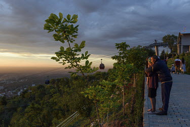 People are watching sunset from Kok Tobe, a mountain (1130 metres) on the south-eastern outskirts of the city.