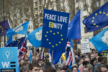 An anti-Brexit protestor marching in central London holds a placard, in the form of an EU flag that reads: ''Peace Love EUnity''.  Organisers claimed a million people came out in support of the ''Put...