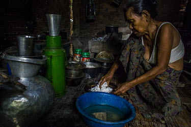 Daw Ma Aung Sein (75) prepares her lunch at her home.