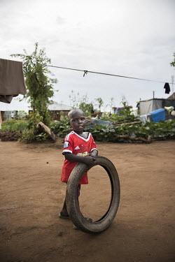 A young boy plays with a tire in Bidibidi refugee settlement.  According to the UNHCR 60% of the refugees fleeing South Sudan are children. As in all Uganda's refugee settlements, the number of childr...