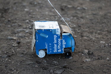 A toy truck, made by a refugee boy living in the Bidibidi camp, constructed out of a cardboard box that formerly contained a solar lamp.   According to the UNHCR 60% of the refugees fleeing South Suda...