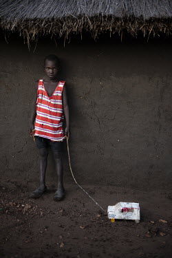 Alex Muga (10), a refugee boy living in the Bidibidi camp, with his toy car he made out of discarded cardboard boxes. According to the UNHCR 60% of the refugees fleeing South Sudan are children. As in...