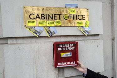 A man holds up a novelty box containing Oxazepam, a drug used to combat anxiety, outside the Cabinet Office on Whitehall as demonstrators on the ''Put it to the People'' march made their way through c...