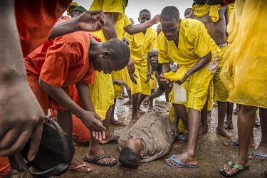 A supporter plays a dead body, symbolising the death of 'Manchester United', the losing side in a prison football match. The match was played at Luzira Prison between teams composed of inmates, Liverp...