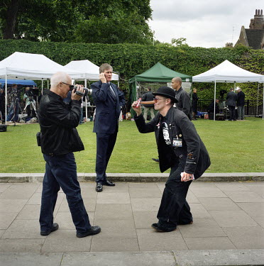 A man films a candidate from a novelty political party on College Green on the day Gordon Brown took over as Prime Minister. Often referred to as College Green, Abingdon Street Gardens is the small pa...