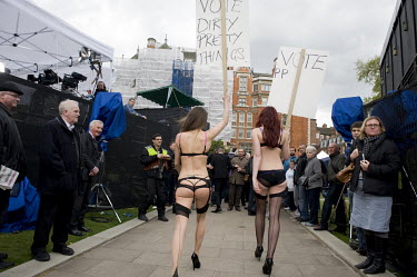 Scantily clad women hold placards reading 'vote dirty pretty things', a publicity stunt for a fashion retailer on College Green five days after Election Day when a new government was formed by the Con...