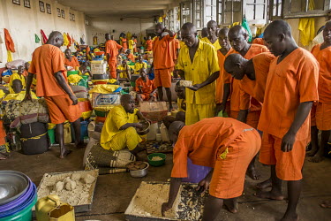 Players eat a meal at Luzira Prison before a match between prison sides. A league, made up of several sides named after UK Premier League sides, operates throughout the year at prison with matches wat...