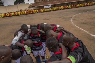 A team named after Liverpool FC huddle before a final against another side named after Manchester United played at Luzira Prison. A league, made up of several inmate sides named after UK Premier Leagu...
