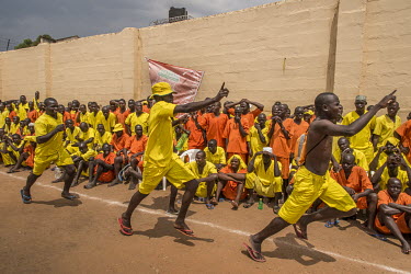 Fans celebrate a goal as inmates watch a football match played at Luzira Prison between teams composed of inmates, Liverpool FC versus Manchester United. A league, made up of several sides named after...