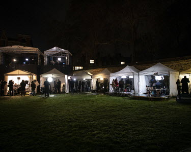 Television crews' tents illuminated at night on College Green on the day the British Prime Minister Theresa May survived a 'Vote of No Confidence' in The House of Commons during the ongoing Brexit deb...