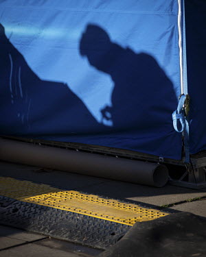 A journalist's shadow falls on a media tent on College Green during reporting of a tense Parliamentary session where MPs discussed the Prime Minister's Brexit deal in nearby House of Commons. This fol...