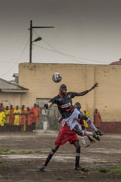 A match played in the rain at Luzira Prison between teams composed of inmates, Liverpool in black versus Manchester United in Red. A league, made up of several sides named after UK Premier League side...
