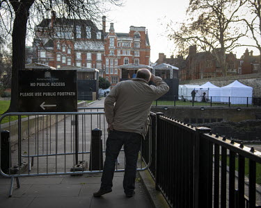 A man standing beside a 'no access' sign on College Green where the media are covering ongoing Brexit negotiations in the nearby Houses of Parliament, following the 2016 Referendum in which the countr...