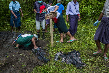 Mahouts digging the buried remains of dead baby-elephant Mi Chaw in order for her guardian vet Dr. Myo Min Aung to restore and keep a memory, at Thayatsan elephant camp. Several months before, a group...