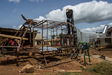 Daouda Bisaso, the props man for Isaac Nabwana's Ramon Studios, builds an helicopter using salvaged pieces of steel and metal sheets.  In the Wakaliga slum, Isaac Nabwana and his Ramon Studio has put...