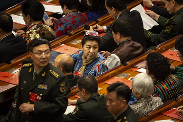 An ethnic Uighur (Uygur) delegate looks back at other delegates sitting in the Great Hall of the People on the closing day of the 12th National People's Congress (NPC).