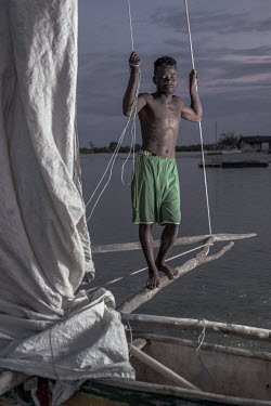 Joe Tahim (24) on his boat which he uses to transport dried fish and other marine produce from from his village of Amasilara to the village of Tampolove, where it will be sold. [This photo story was s...