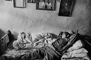An elderly Roma man resting on a bed. He and his wife live in one room in the Roma settlement of Patorak. The settlement is built on the site of the former Ondrej mine and is in constant danger of col...