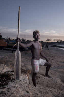 Lucien Diseremo (26) during a beach cleanup. Diseremo is a spear fisherman, but always joins efforts to clean up the beach when there is word that tourists might be coming. Tourism is one of the incom...