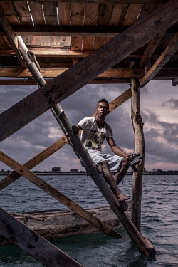 Petain Xavier Faralahi (22) works as a guard in the sea-cucumber fields of Tampolove village. He does 12 hour shifts, making sure the valuable sea-cucumbers are not stolen from their pens. Faralahi is...