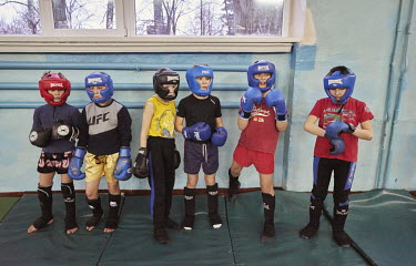 Children wearing head protectors at a Thai boxing lesson.